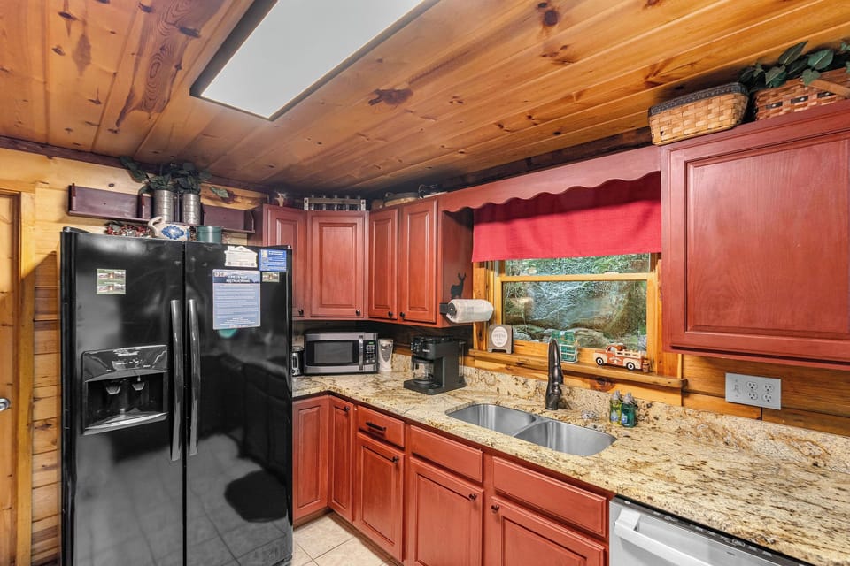 Full kitchen with red wood cabinets
