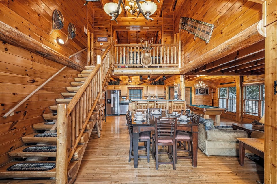 Relax in this spacious, rustic cabin with vaulted ceilings, a loft overlooking the dining area, and cozy seating perfect for gathering with loved ones.