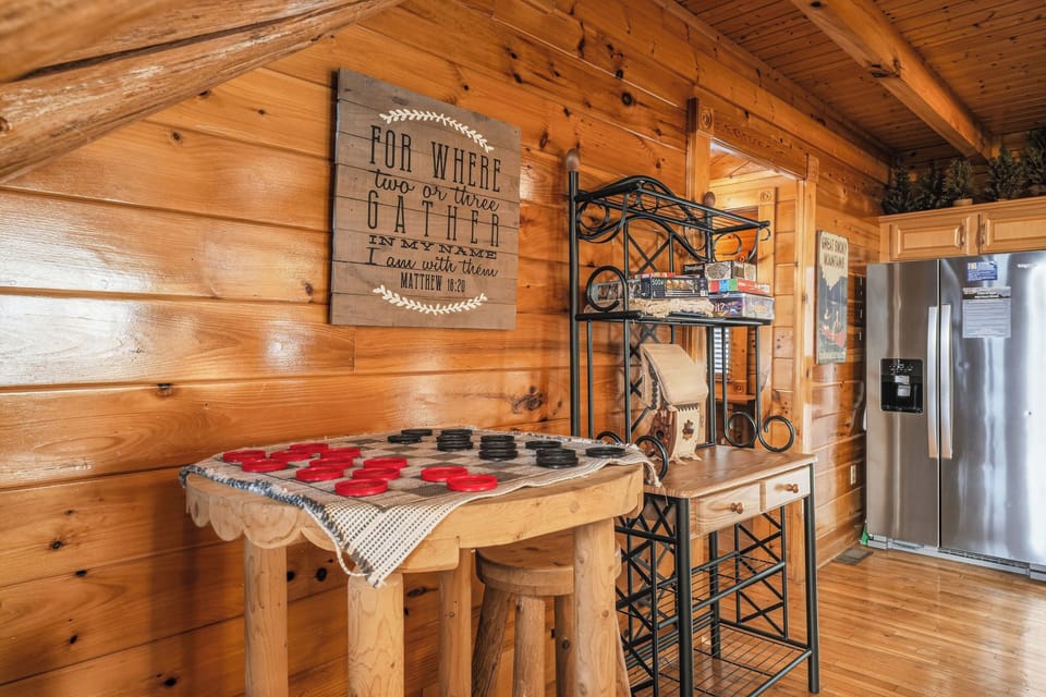 Your fully-equipped kitchen features a charming rustic feel, complete with a large refrigerator, cozy breakfast bar, and thoughtful touches that make cooking feel like home.