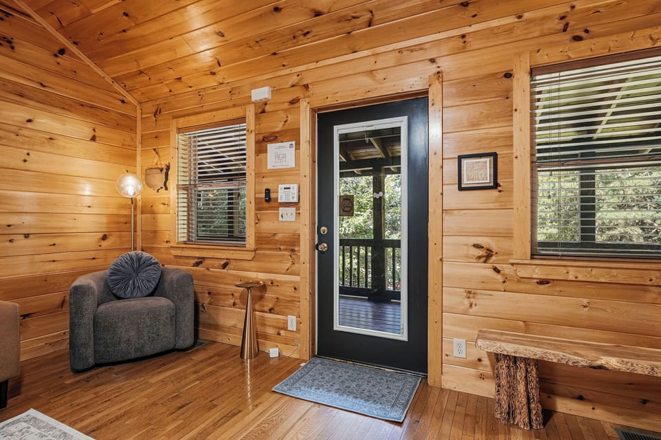 Step inside your inviting log cabin retreat, where warm wood tones and cozy furnishings welcome you home. Sunlight filters through the windows as you settle into the comfortable armchair after a day of adventure.