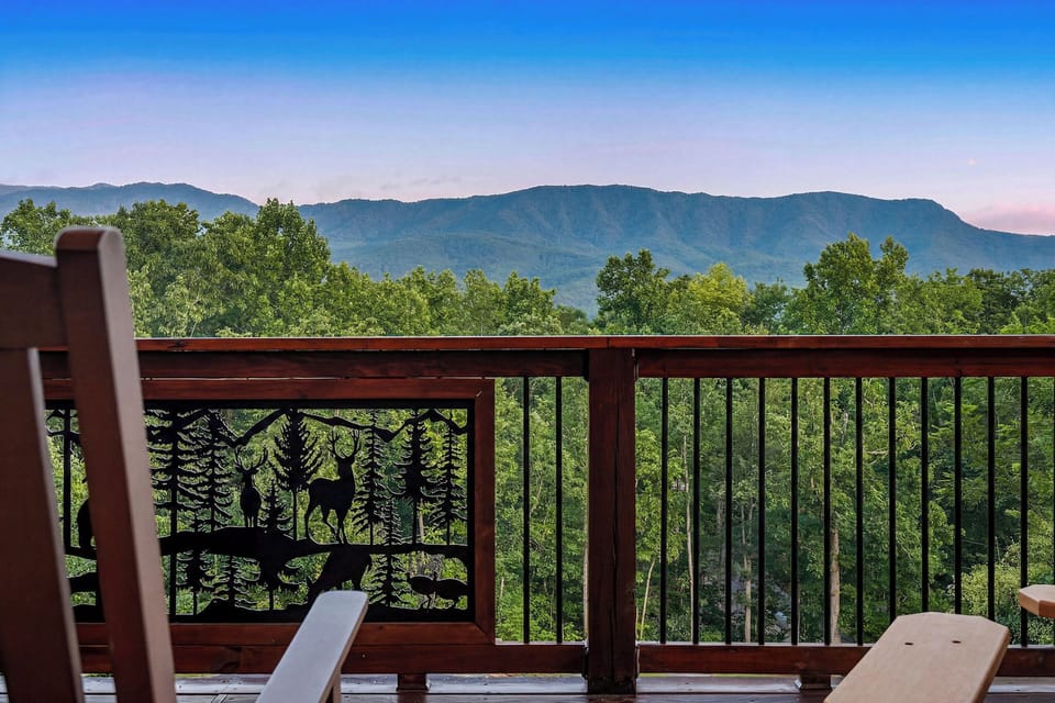Unwind on a private deck surrounded by lush forest with sweeping views of majestic mountains. This peaceful retreat offers the perfect spot to relax and soak in nature's beauty.