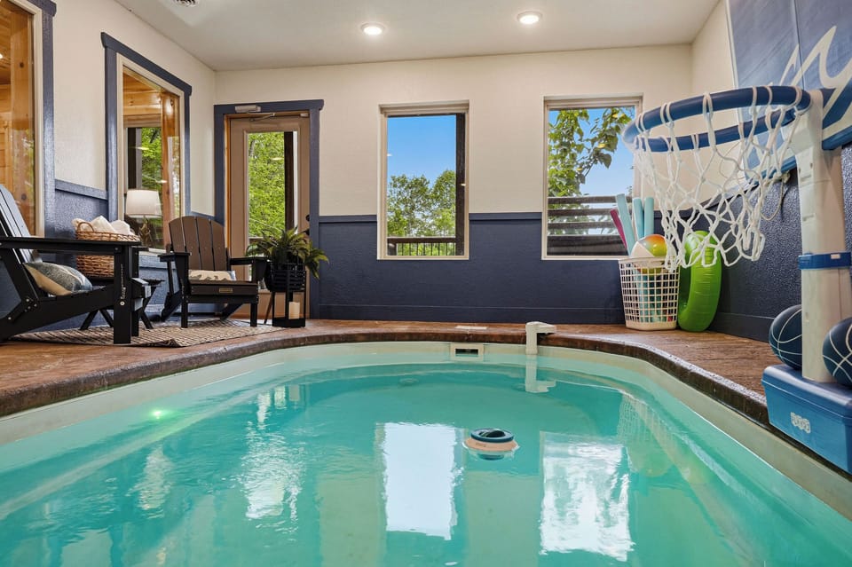 Slip into your private indoor pool anytime—warmed water, lounge seating, and a hammock swing create your own cozy escape, perfect for relaxing after exploring nearby adventures.