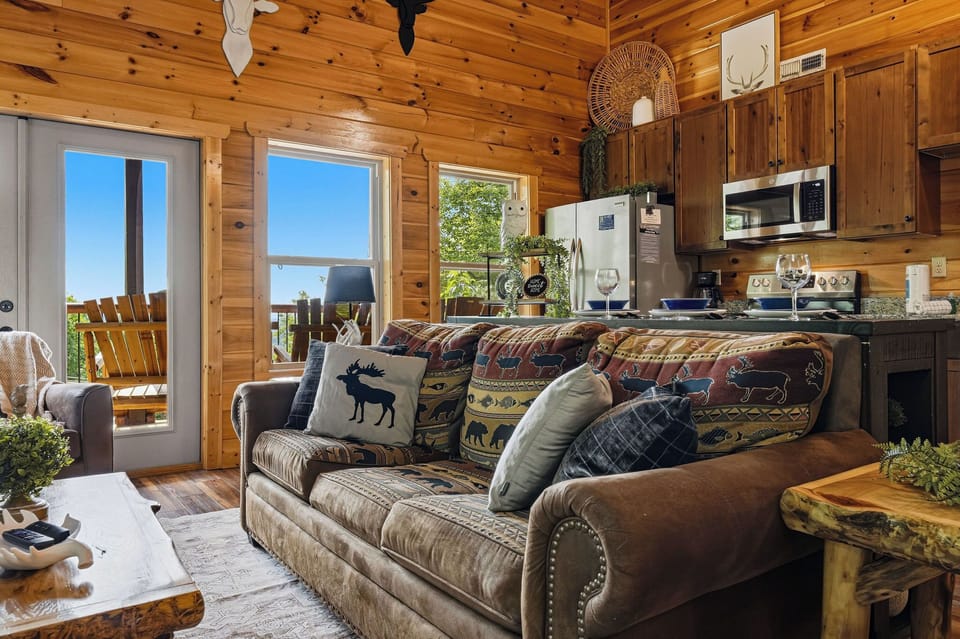 Step into this cozy cabin where rustic pine walls and charming wildlife accents invite you to unwind. Your open living space flows to a deck, perfect for morning coffee with nature's backdrop.
