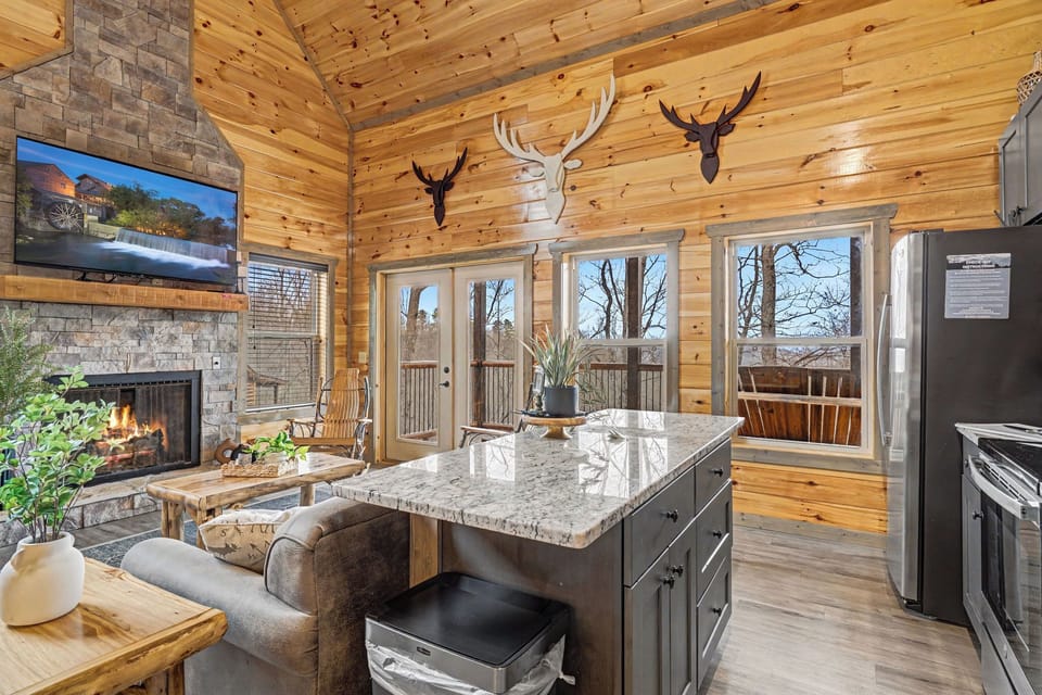 Cozy up in this stunning cabin where rustic charm meets modern comfort—crackling fireplace, granite island, and forest views await.