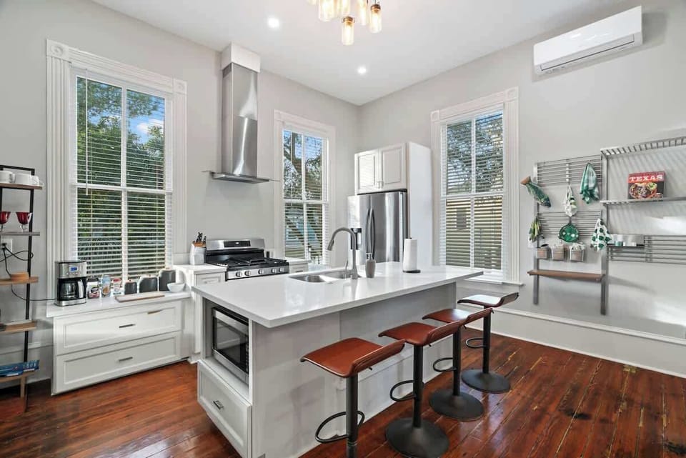 Our modern kitchen has seating with the kitchen island as well as around the corner. The kitchen is fully stocked with all the supplies you need to cook a great meal together! We also provide coffee with all the fixings! 