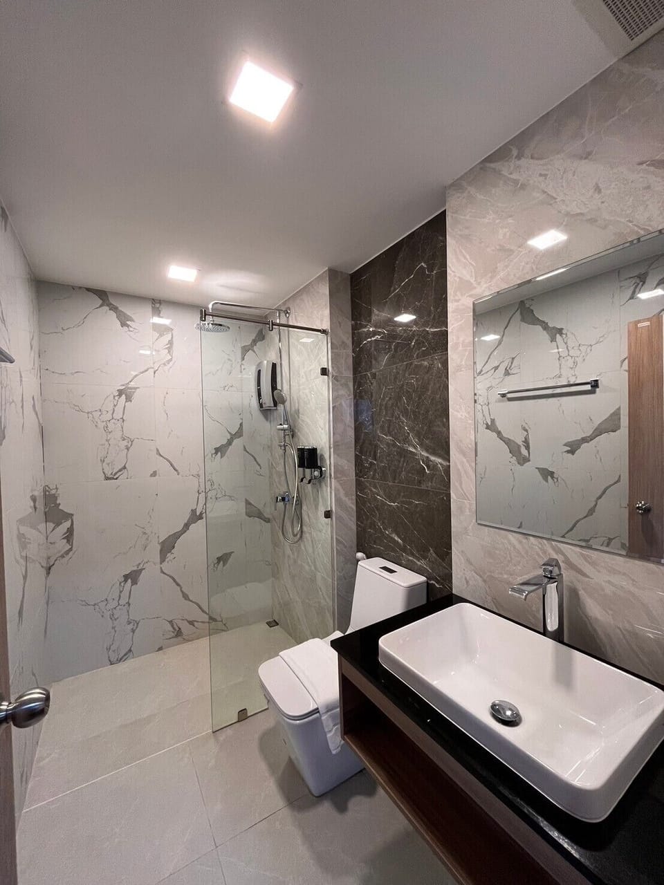 Shower, rainfall showerhead, hair dryer, towels