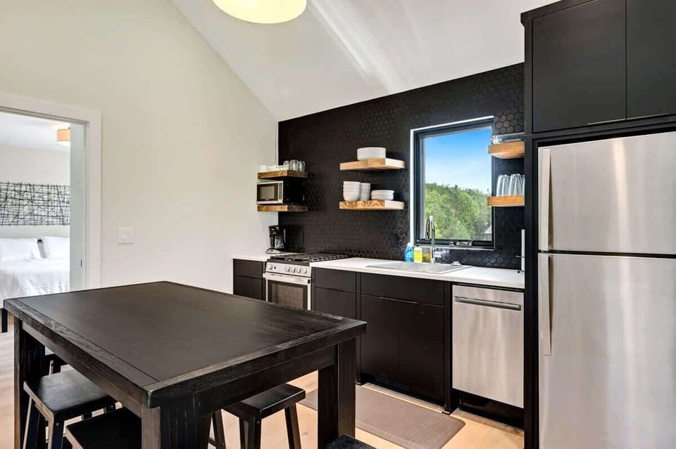 Experience the seamless combination of comfort and design in this meticulously appointed and distinct living area. Embrace the continuation of the open concept theme as it gracefully extends into the well-stocked kitchen, effortlessly bridging the realms of dining and relaxation.