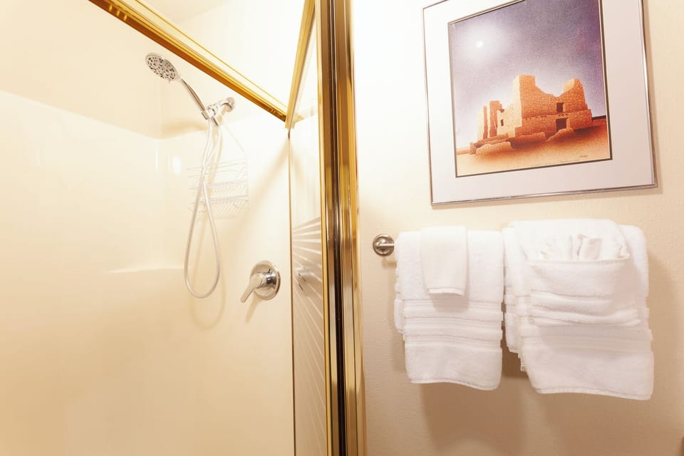 Step into your own sparkling bathroom with fresh towels and a rainfall shower, ready for you after a day exploring nearby landmarks.