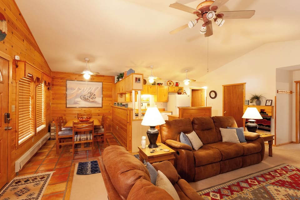 Relax in your cozy cabin-style living space with warm wood finishes, plush leather seating, and everything you need for a comfortable mountain getaway.