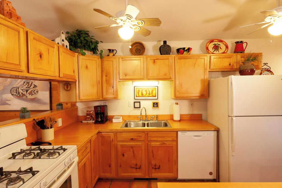 Your fully-equipped kitchen features warm wood cabinetry, modern appliances, and charming Southwestern décor—perfect for preparing meals during your stay.