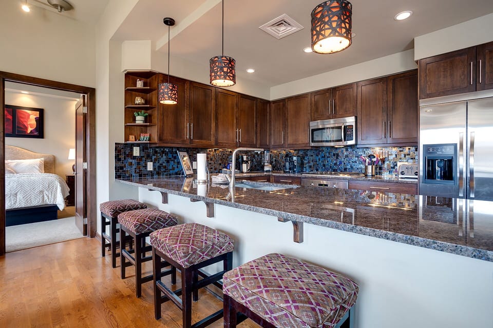 Your gourmet kitchen awaits with granite counters, stainless appliances, and a breakfast bar perfect for morning coffee or evening wine.