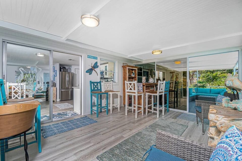 Mix a drink and open all of the glass doors to lead out to the pool