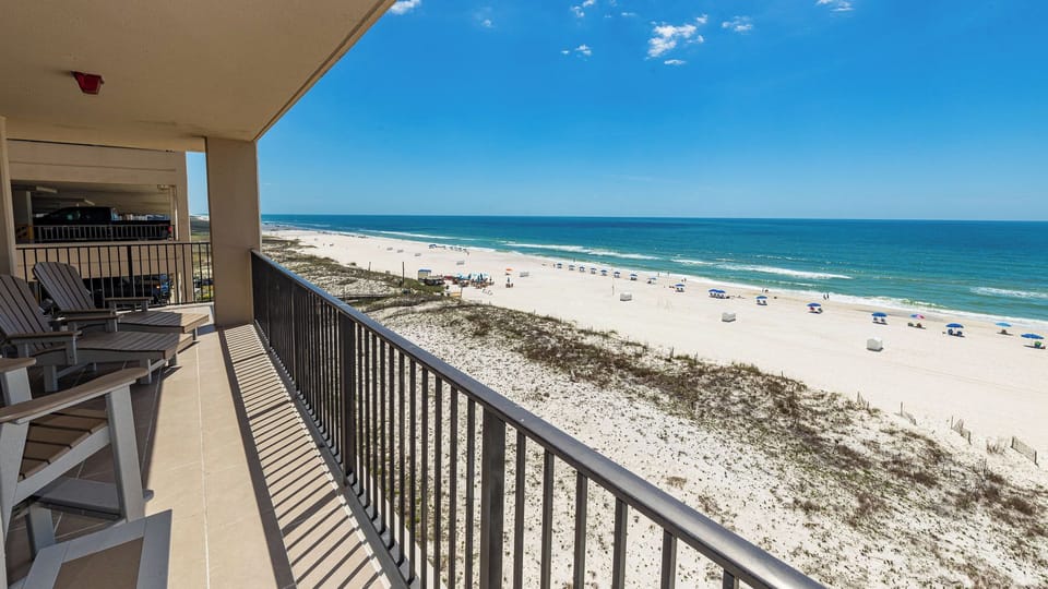 Chairs on the balcony invite you to relax while listening to the rhythmic sound of waves on the coast