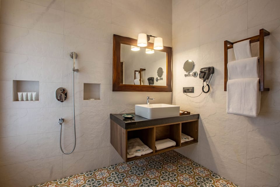 Hydromassage showerhead, designer toiletries, bathrobes, slippers