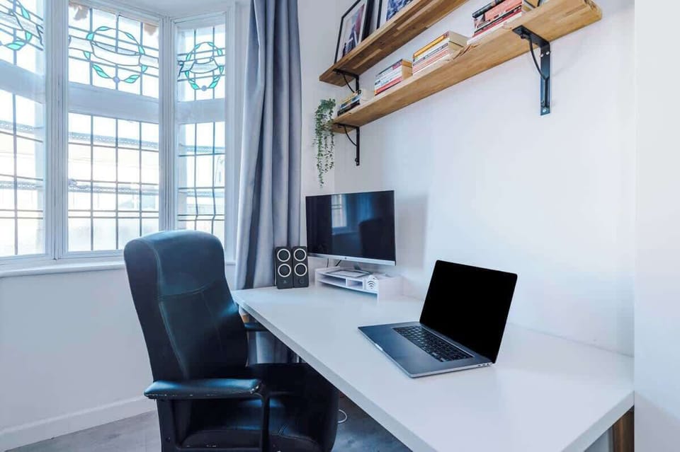 Bedroom 2 benefits from a comfortable king bed, a desk with monitor and plenty of storage.