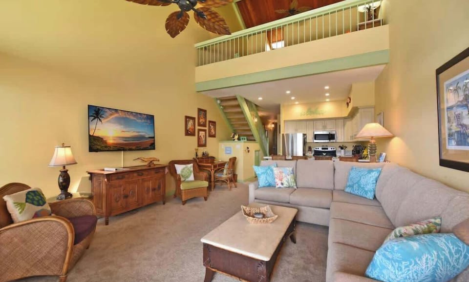 Living room features a sofa sleeper, smart tv with cable, ceiling fan, word desk, and plenty of seating. 