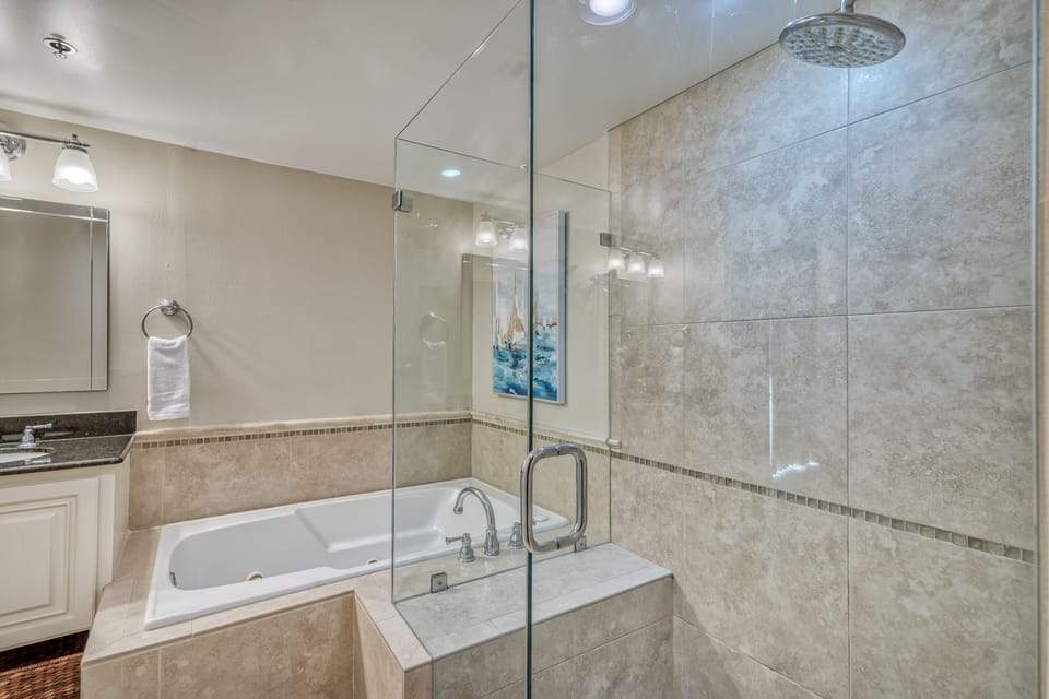 Gorgeous tiled walk in shower and large jetted soaking tub.