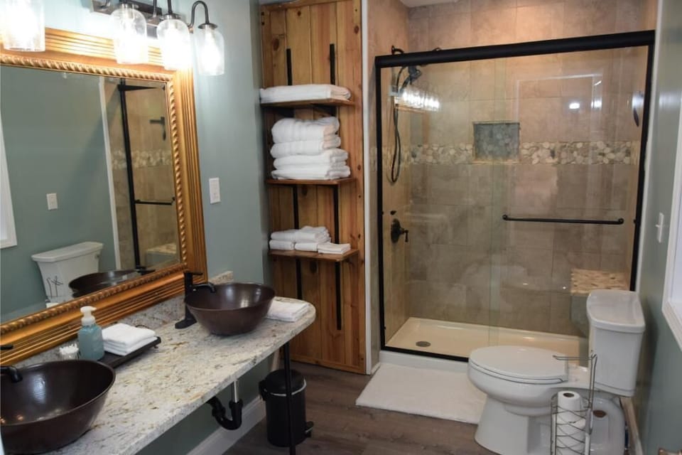 Custom Master Bathroom.  Note tile work and handmade shelves. Dual shower head.