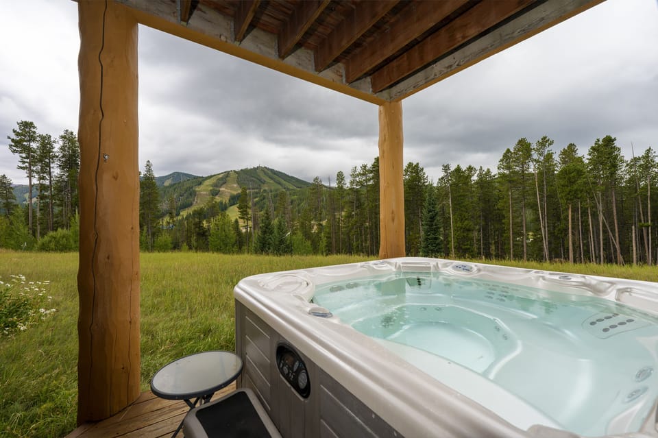 - Private outdoor hot tub with panoramic mountain scenery for ultimate relaxation   - Covered deck ensures year-round enjoyment in any weather   - Peaceful setting with nature views perfect for unwinding after adventure
