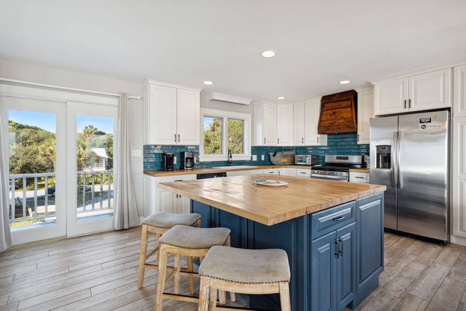 Open concept kitchen with top of the line stainless steel appliances