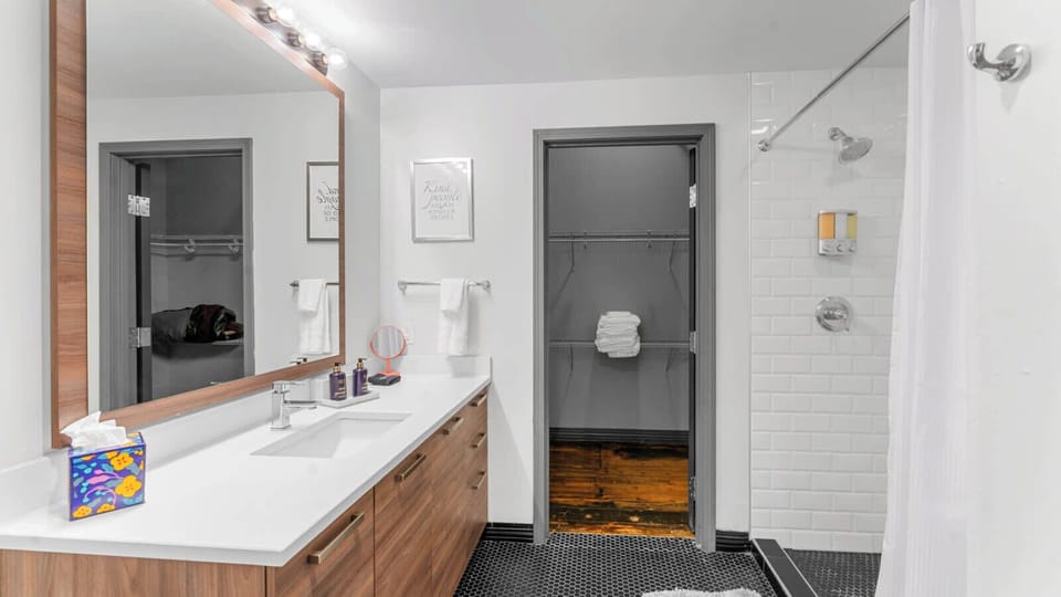 Bathroom Oasis: Bright, stylish space with sleek fixtures and cozy towels for your relaxation.
