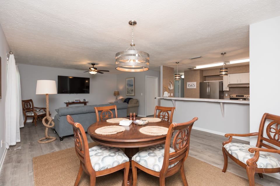 Dining area looking into living room and kitchen