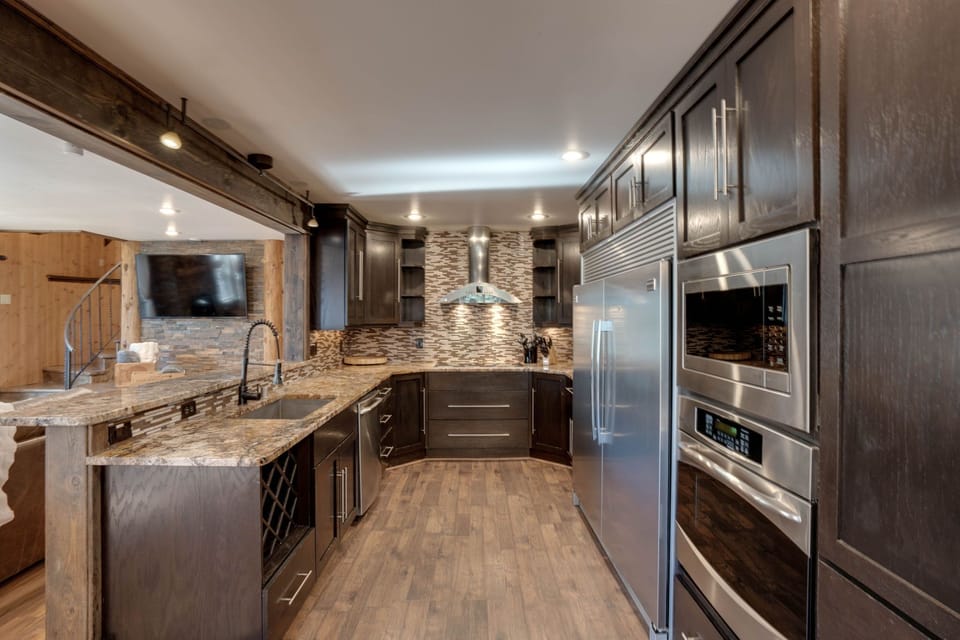 Kitchen with industrial fridge and bar top