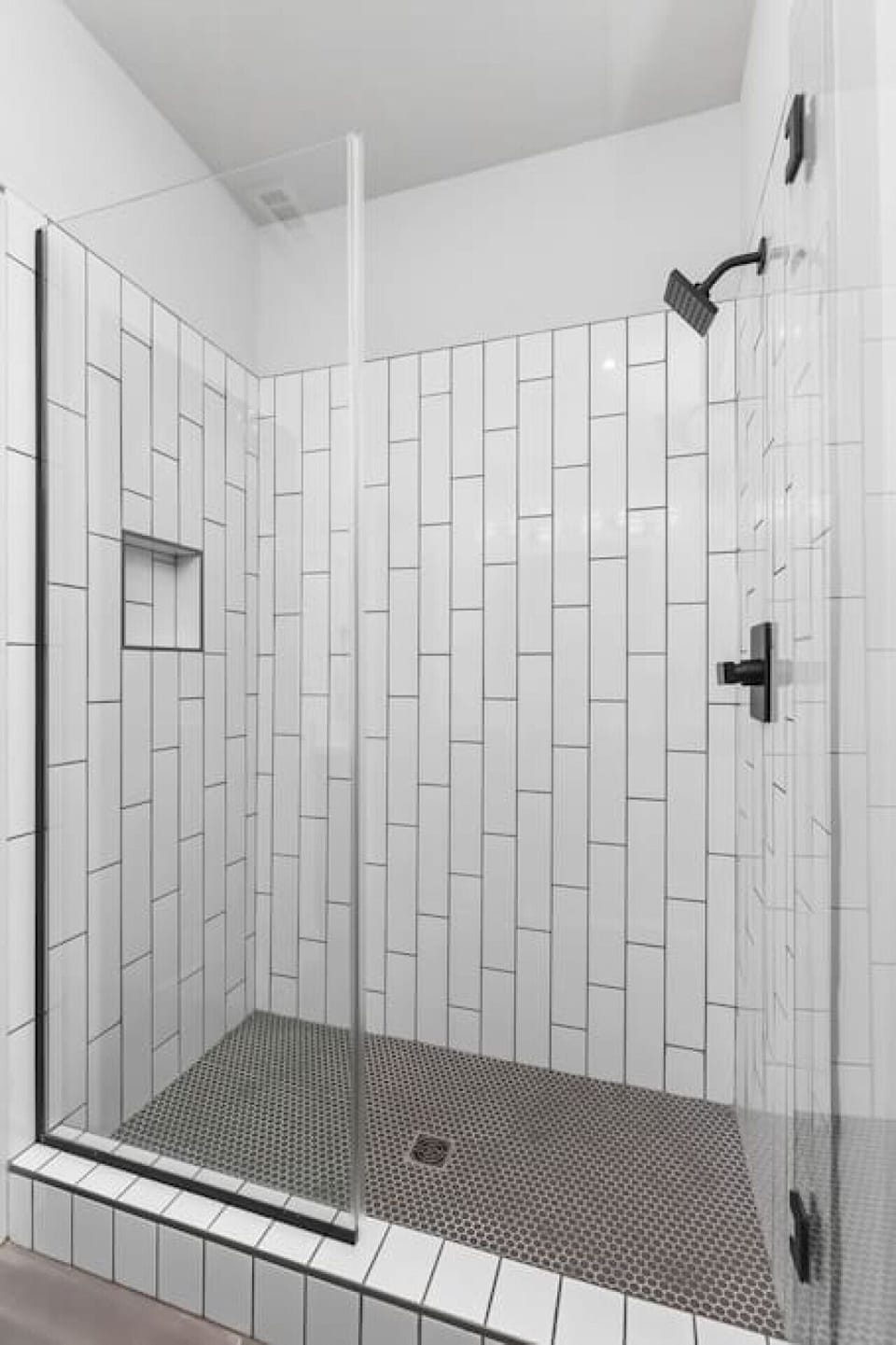 Standing shower in the primary bedroom's ensuite bathroom. The condo is stocked with all the basics you'd need for your stay.