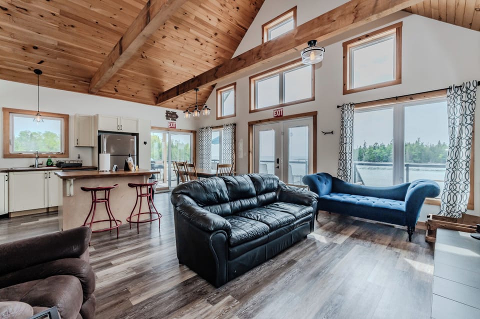 This gorgeous 2 storey cottage features an open concept kitchen and living area, with plenty of space for lounging and large windows to take in the view of the water!