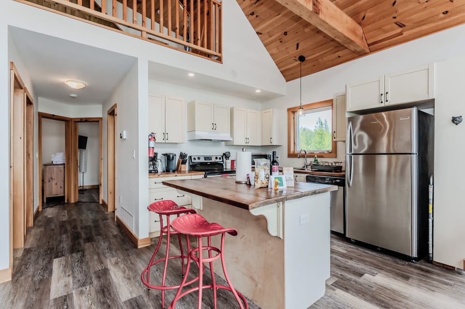 The kitchen is designed with ample counter space and modern amenities, including a dishwasher, microwave, and coffee maker. Ideal for preparing meals with ease.