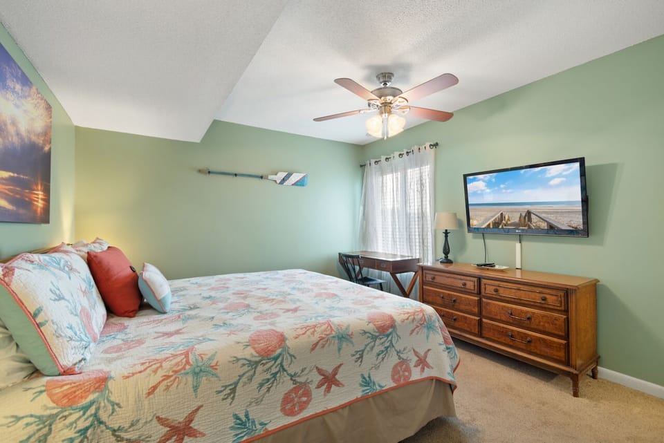 Drift into coastal dreams in your peaceful bedroom with soothing sea-glass walls and pristine bedding.