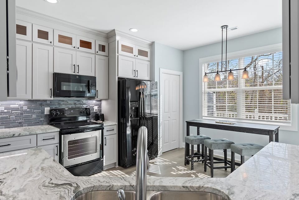 Your gourmet kitchen features marble countertops, modern appliances, and a breakfast bar where you can enjoy morning coffee.