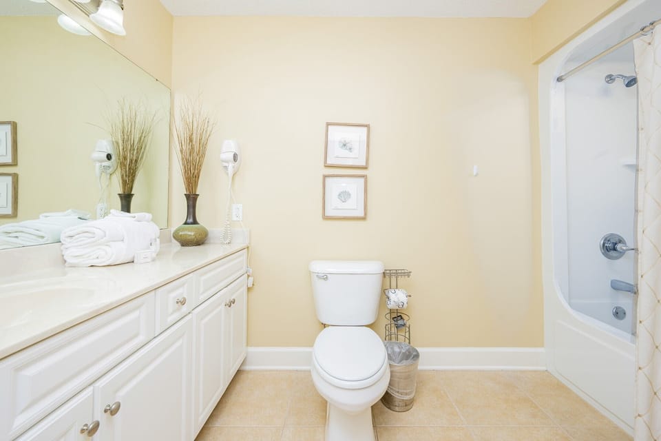 Freshen up in this guest bath in the relaxing shower or soothing tub before an exciting beach day