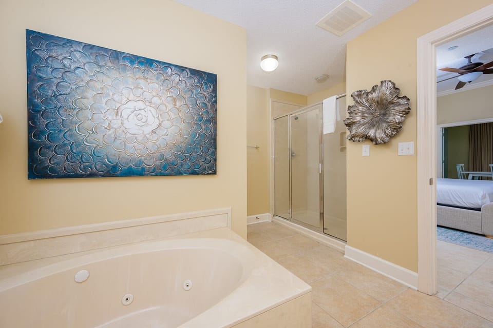 Refresh in the master bath after a day at the beach with a soothing jetted tub and relaxing walk-in shower