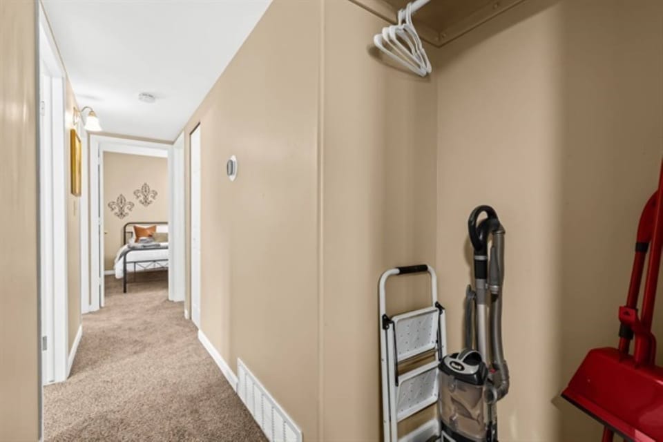 Step into comfort from this clean and organized hallway that leads to a warmly decorated and inviting bedroom