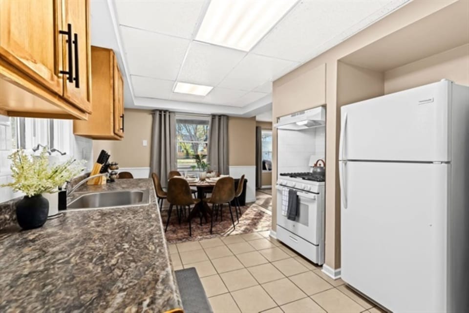 Spacious and inviting kitchen with all the essentials, ready to host your memorable meal preparations and gatherings
