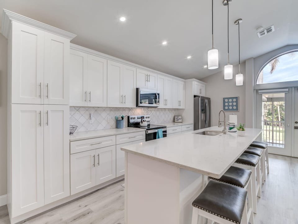Kitchen Oasis: Bright white cabinetry and sleek countertops create a culinary paradise!