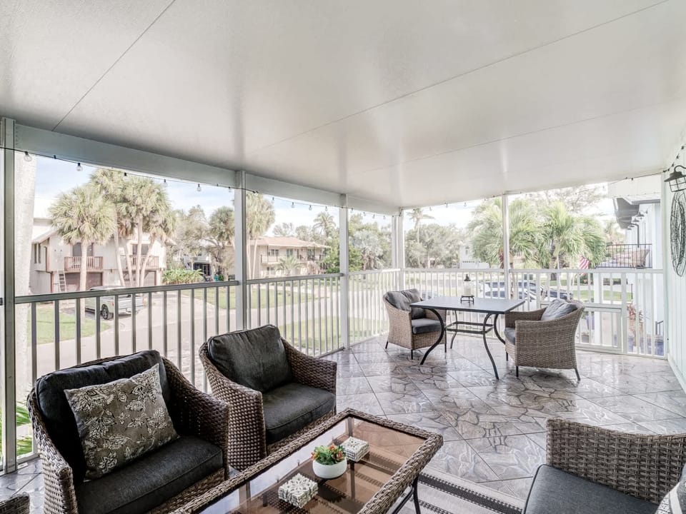 Delightful and breezy front screened porch. Both dining and conversation areas here.