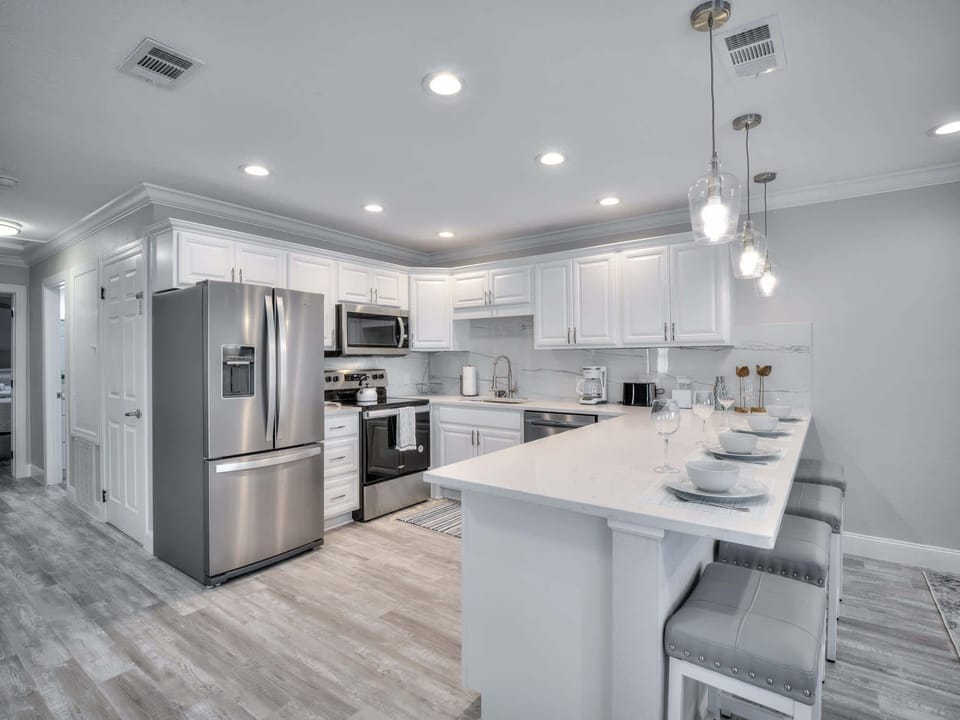 Spacious well equipped kitchen with counter height seating