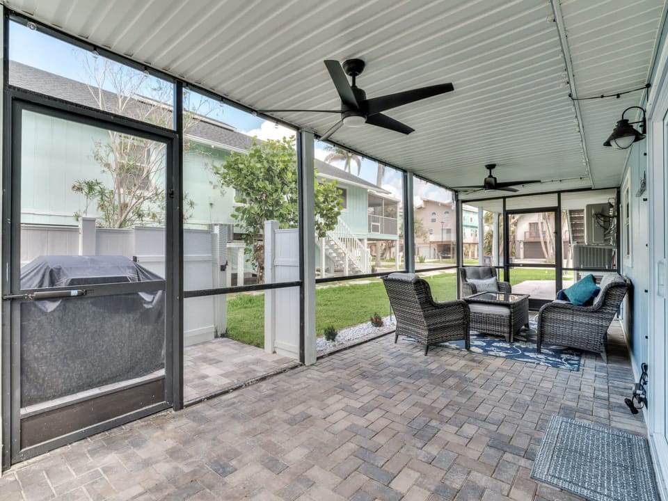 Private screen porch conversation area next to grilling area