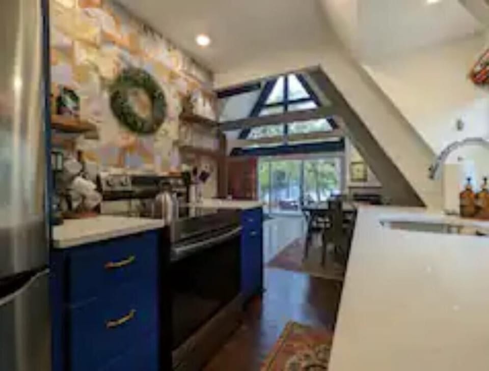 Stainless steel refrigerator and electric 5 burner stove and single oven.