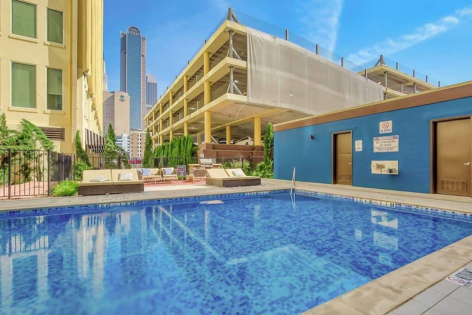 Pool Area: Dive into relaxation at this stunning pool with vibrant tiles and lounging spaces!