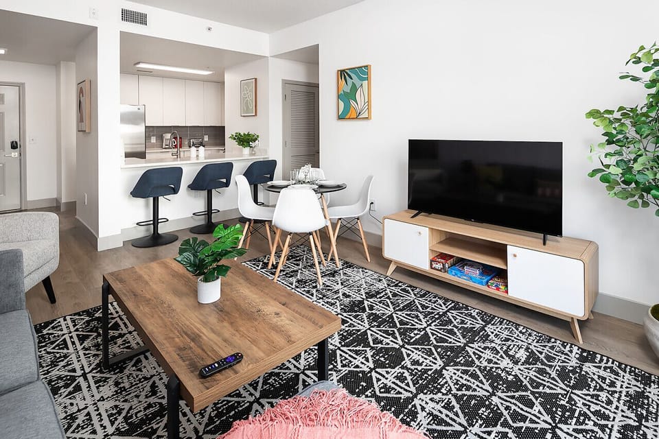 Unwind in the spacious living area complete with a comfy couch, 50-inch TV, and dining area!