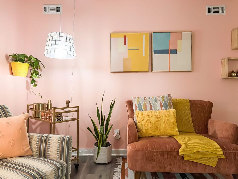 Intimate corners and cozy nooks define our living room. A small couples chair meets a reading haven, all bathed in ambient mood lighting. And for those moments of literary escape, our mini bar awaits—a perfect spot to grab a drink and lose yourself in a g