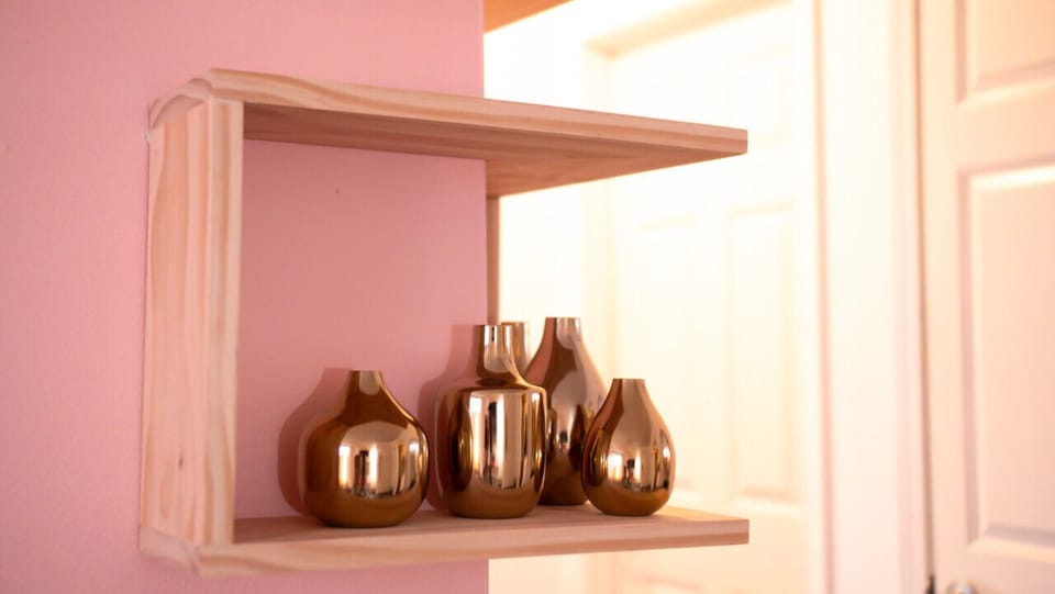Admire the unique charm of our custom corner wrap-around shelves, showcasing a curated blend of treasures. The gleaming brass art adds a touch of sophistication, turning this corner into a visual delight. Discover the intersection of style and craftsmansh