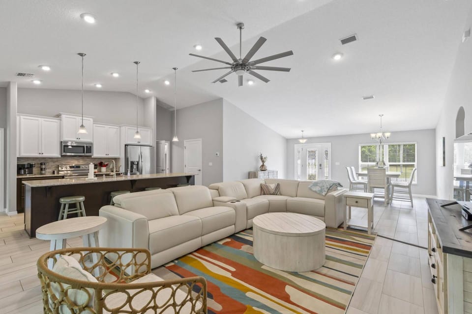 Bright and airy open-concept living room with generous seating area, perfect for socializing.