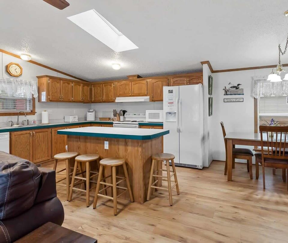 Main home kitchen with island seating & all-new LVT flooring