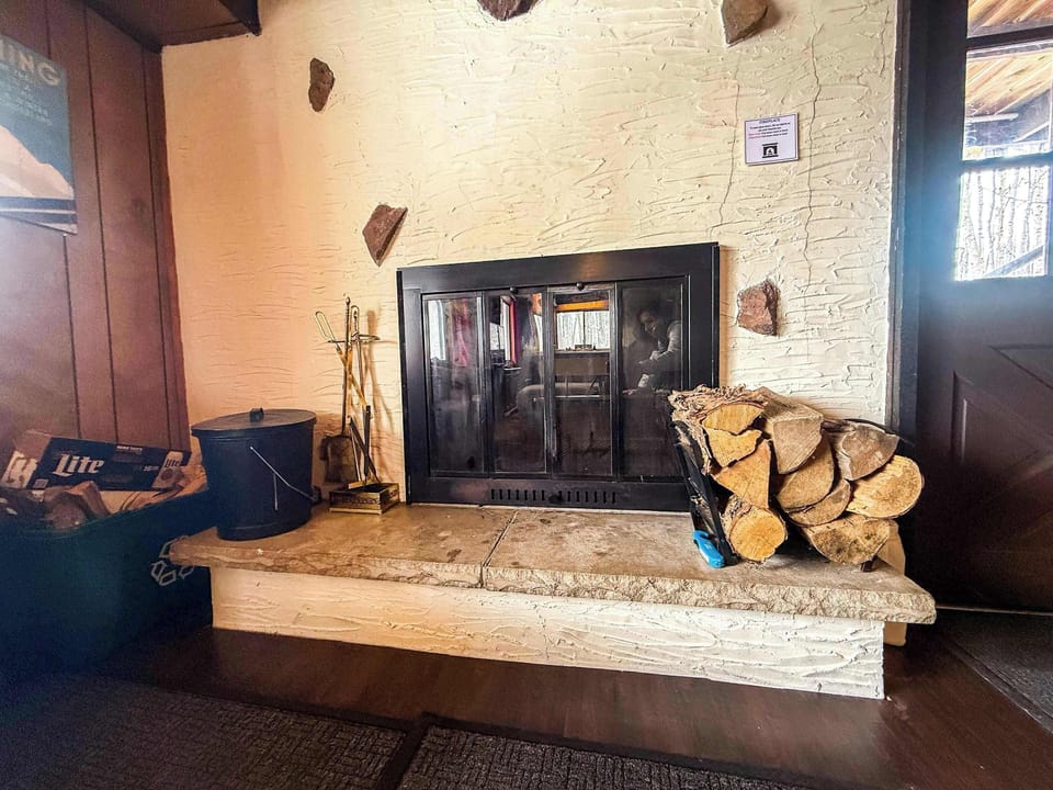 This wood fireplace is a perfect place to cozy up after a long day on the slopes. 
