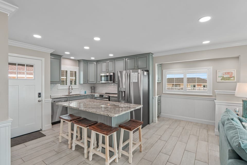 Your spacious open kitchen features granite countertops, stainless steel appliances, and an island perfect for cooking together.
