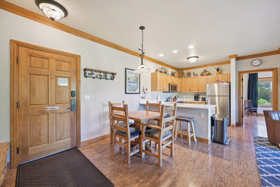 Step into your open-concept retreat where warm wood tones and modern amenities create the perfect space for cooking, dining, and gathering together.